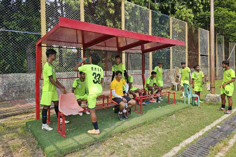 Players take a breather during a water break. The broken seats need to be replaced. 