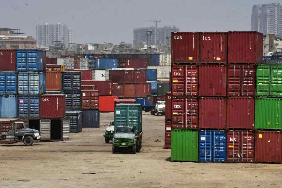 Trailers move through a shipping containers yard near port area, in Karachi, Pakistan, Friday, June 12, 2026.