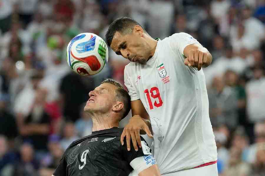 Iran's Ali Nemati (19) battles for the ball with New Zealand's Chris Wood (9) during the World Cup Group G soccer match between Iran and New Zealand in Inglewood, Calif., near Los Angeles, Monday, June 15, 2026.