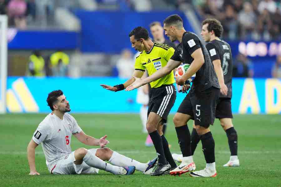 Iran's Saeid Ezatolahi reacts after a challenge from New Zealand's Michael Boxall as referee Cesar Arturo Ramos intervenes during the Fifa World Cup 2026 Group G match at Los Angeles Stadium in Inglewood, California, on June 15, 2026.