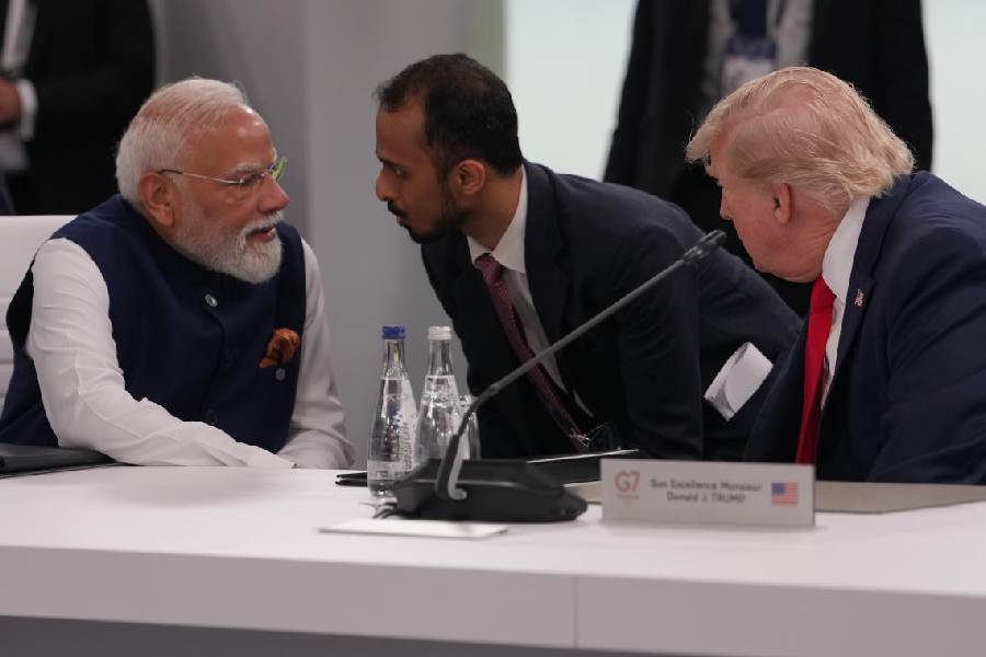 India's Prime Minister Narenda Modi talks to US President Donald Trump before the plenary session at the G7 summit, Tuesday, June 16, 2026, in Evian-les-Bains, France.