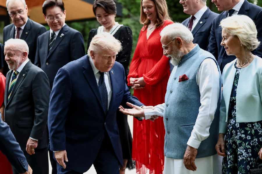 Indian Prime Minister Narendra Modi offers a hand to U.S. President Donald Trump during a family photo before a cultural performance and concert during the G7 summit, in Evian-les-Bains, France, June 16, 2026.