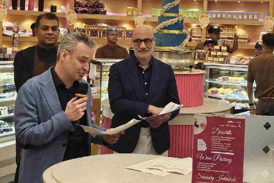 Alliance Francaise du Bengale director Marc Boudin addresses guests as Olivier Thiénot and Vikas Kumar look on