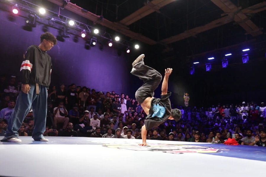 Wild Child smoothly lands on one hand after a jump to showcase his power move