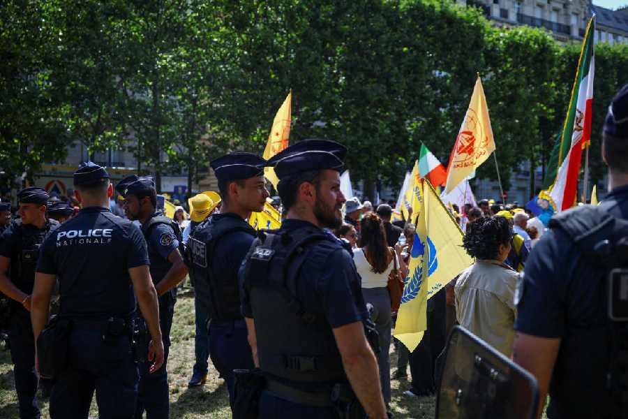 French police stand guard in front of people attending a demonstration against political executions in Iran and in support of a democratic republic, a demonstration which was banned by Paris Police Prefecture, in Paris, France, June 20, 2026. (Reuters)