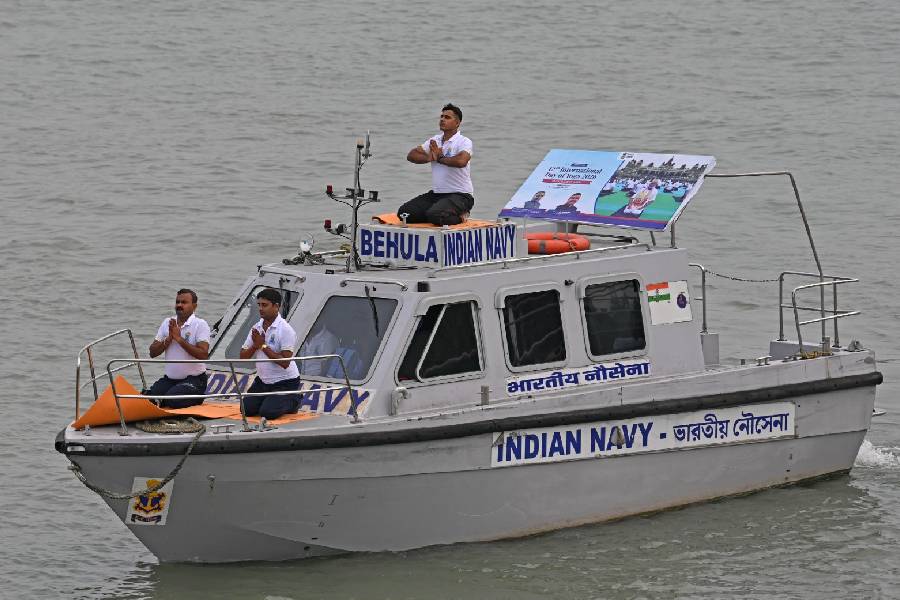 Indian Navy officers strike poses on the Hooghly River