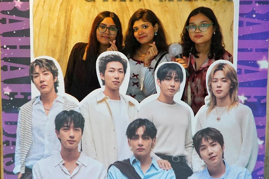 Fans pose for pictures at a BTS-themed photobooth