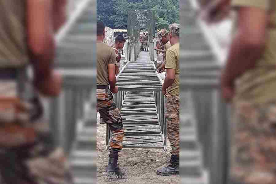 Army personnel build a foot overbridge over the Balason river at Dudhia on Tuesday
