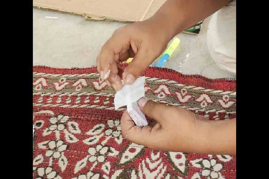 Cut a piece of canvas and glue across the spine of the pages. A cloth bag can be used for this
