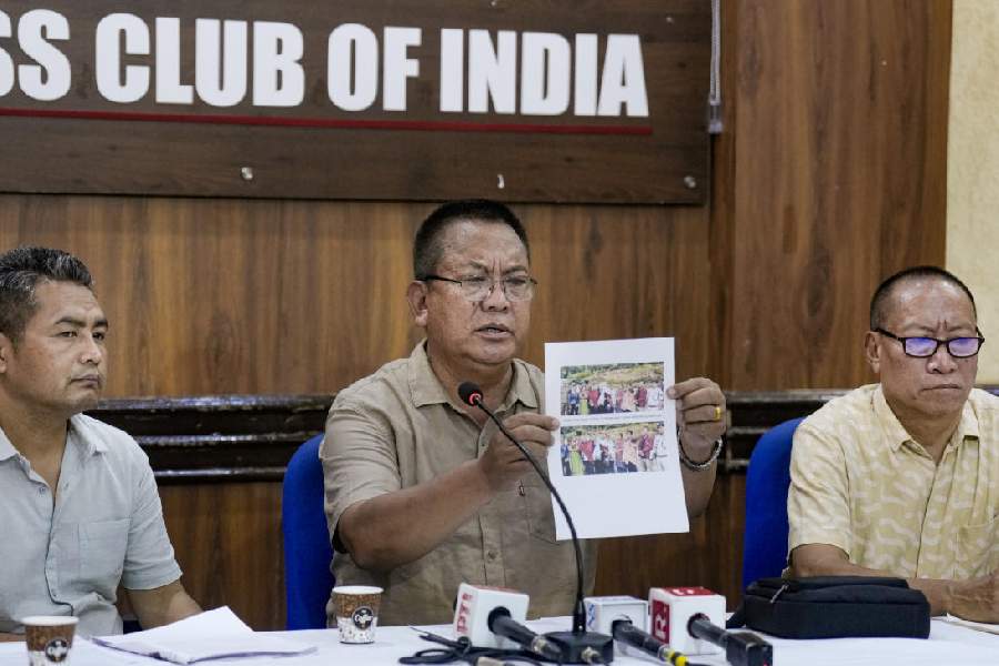 United Naga Council (UNC) leader KS Paul Leo, centre, displays photographs while addressing a press conference on the situation in Manipur at the Press Club of India, in New Delhi, Saturday, June 27, 2026.
