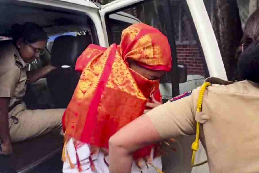 Police personnel escort accused Siya to the Lonavala Gramin Police Station for questioning in connection with the Ketan Agarwal death case, in Lonavala, Pune district, Wednesday, June 24, 2026.