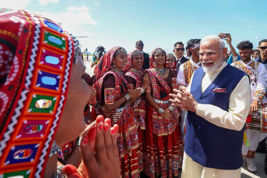 Prime Minister Narendra Modi being welcomed by artistes from Kutch after their performance upon his arrival at the International Airport, in Victoria, Seychelles