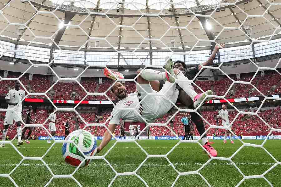 Canada's Jonathan David, right, scores their third goal past Qatar's Boualem Khoukhi, left, during the World Cup Group B soccer match between Canada and Qatar in Vancouver, British Columbia, Thursday, June 18, 2026.