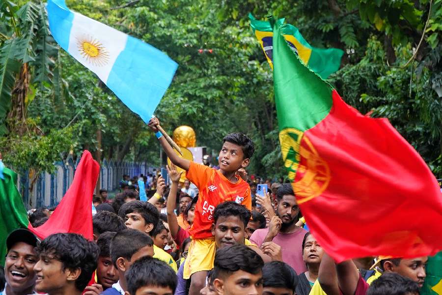 Football lovers and players wave their favourite teams’ flags