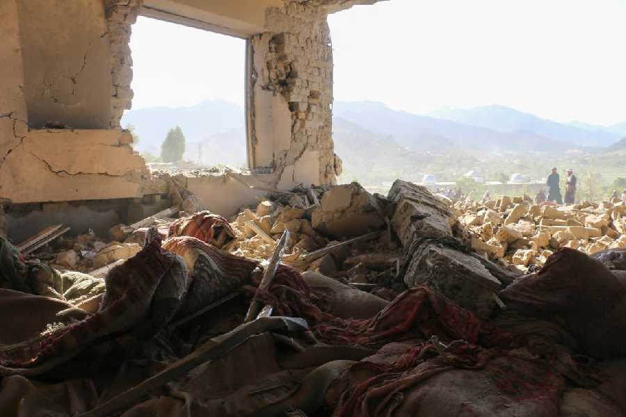 Men speak outside a destroyed building following an airstrike that the Taliban say was carried out by Pakistan's security forces, in Samkani district, Afghanistan, June 29, 2026.