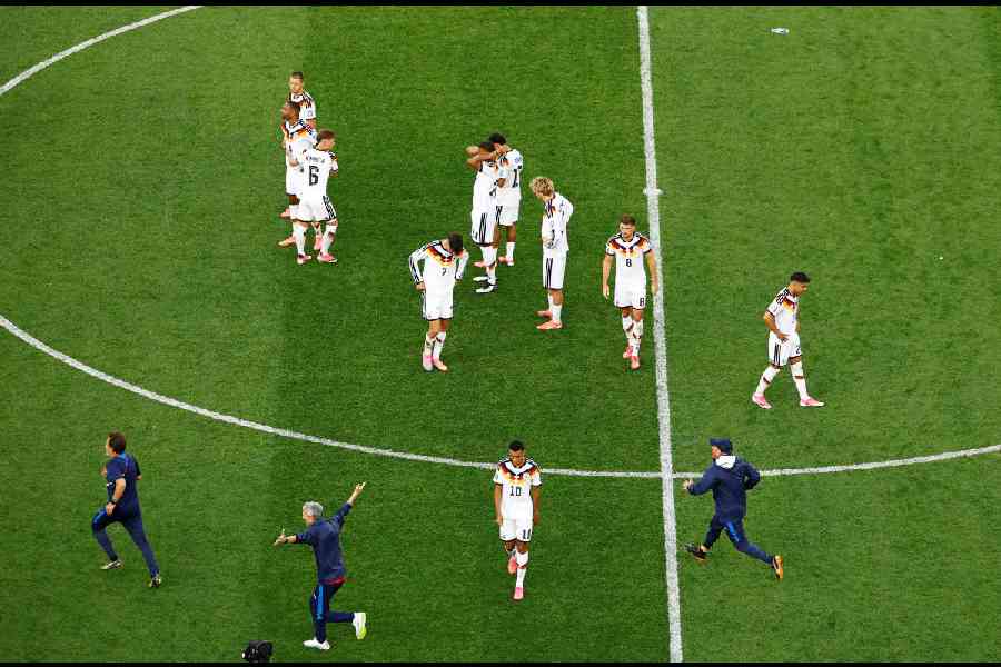 Germany's Jamal Musiala with teammates look dejected after the match as Germany are eliminated from the World Cup. (Reuters)