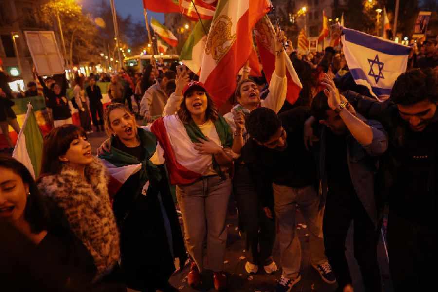 People celebrate the military action against the Iranian regime by the U.S. and Israel, in Barcelona