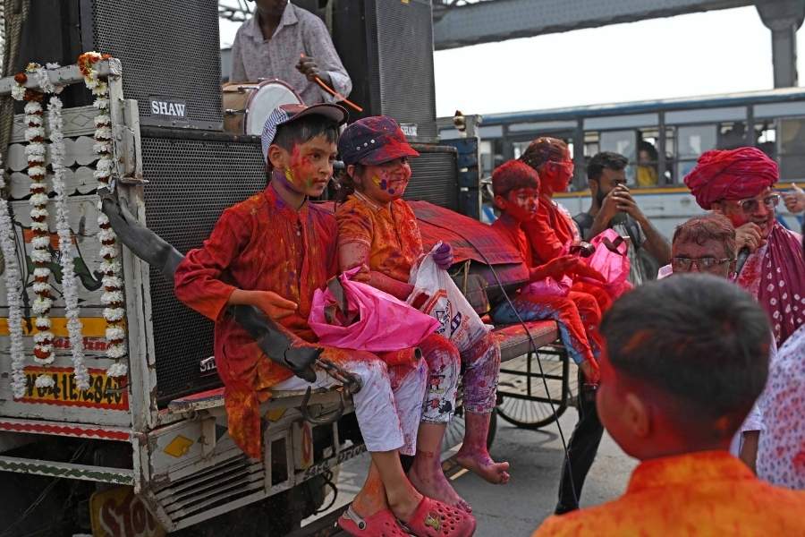 Young members of the family lead the procession for this temple on wheels