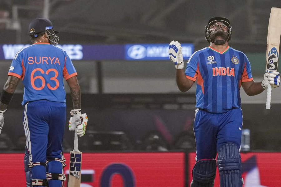 India's Sanju Samson, right, celebrates his half century with captain Suryakumar Yadav during the ICC Men's T20 World Cup 2026 cricket match between India and West Indies, at the Eden Gardens, in Kolkata, West Bengal, Sunday, March 1, 2026.