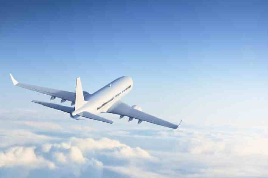 Commercial jet flying above clouds