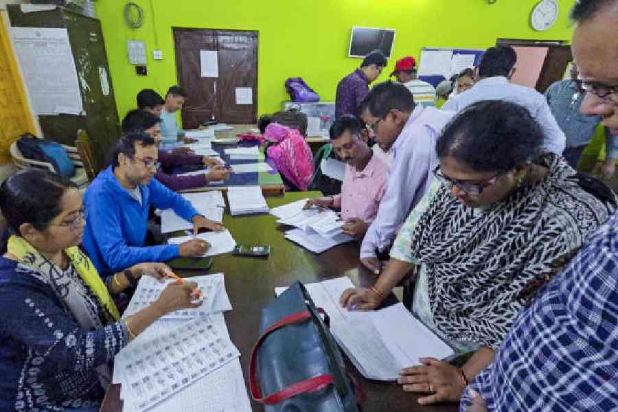People in Birbhum check their names in the voter list on Sunday, a day after the publication of the post-SIR rolls. (PTI picture)