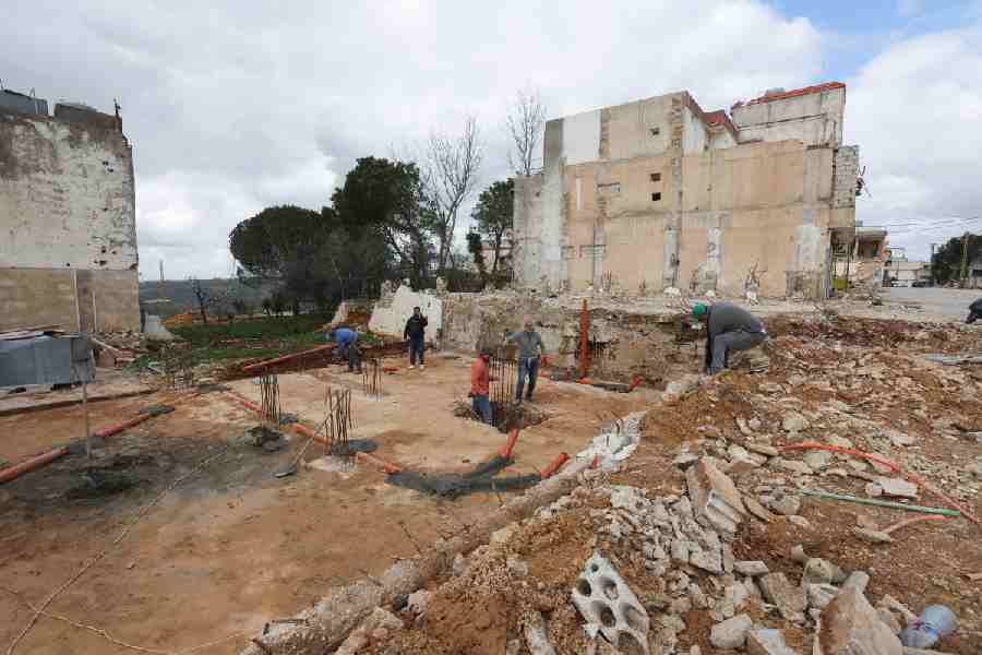 Men work at a construction site that was damaged during the previous hostilities between Israel and Hezbollah, in the Lebanese village of Khiam, near the border with Israel, southern Lebanon, February 19, 2026.