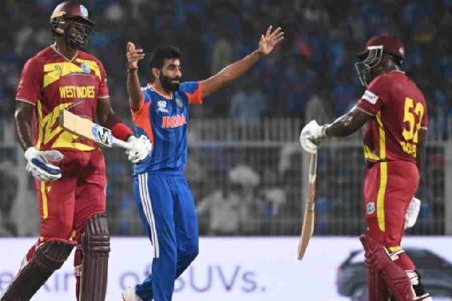 Jasprit Bumrah celebrates with teammates after taking the wicket of West Indies batsman Rovman Powell during the ICC Men's T20 World Cup 2026 match between India and the West Indies on Sunday