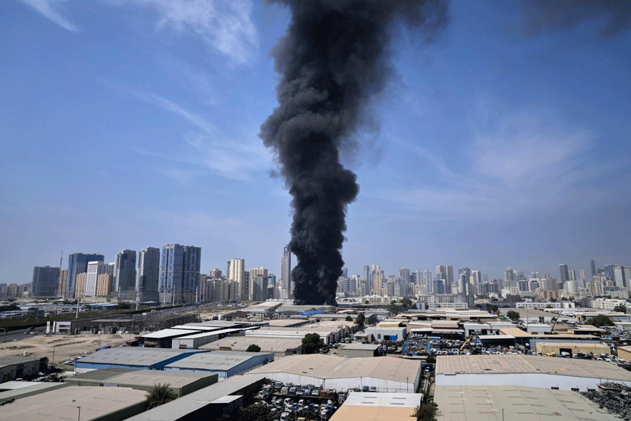 A black plume of smoke rises from a warehouse at the industrial area of Sharjah City in the United Arab Emirates following reports of Iranian strikes in Dubai, United Arab Emirates, Sunday, March 1, 2026.