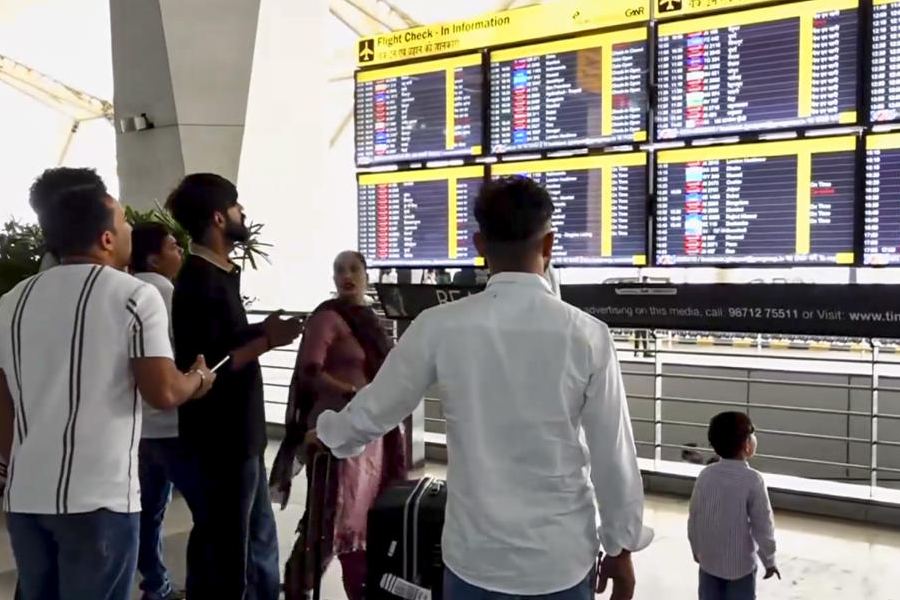 Stranded passengers wait amid cancellation of 350 international flights to the Middle East due to the US-Israel strikes on Iran, at the Indira Gandhi International Airport, in New Delhi, Monday, March 2, 2026.