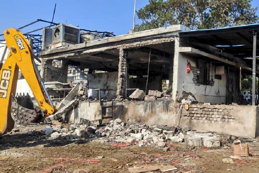 An excavator clears the debris after a blast at an explosives manufacturing factory, in Nagpur district, Sunday, Mar. 1, 2026.