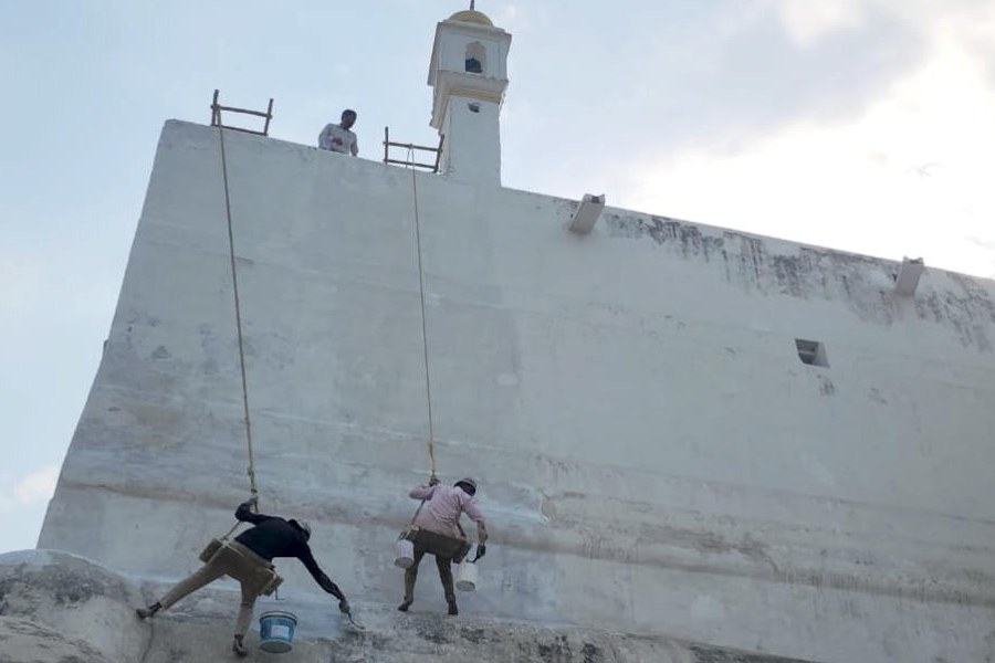 Laborers whitewash the outer wall of the Shahi Jama Masjid following an Allahabad High Court directive to the Archaeological Survey of India (ASI) to complete the task, in Sambhal, Uttar Pradesh, Sunday, March 16, 2025.