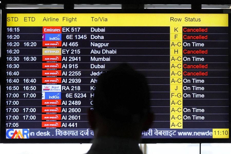 A man views a screen displaying flight information at the Indira Gandhi International airport in New Delhi, India, March 2, 2026.