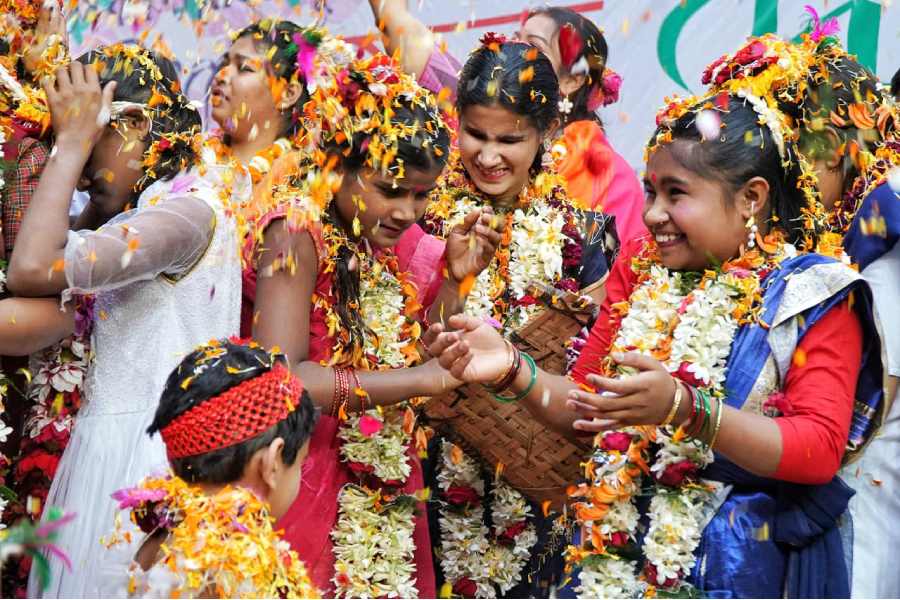 Partially blind children of the Lighthouse for the Blind celebrate Holi with flowers