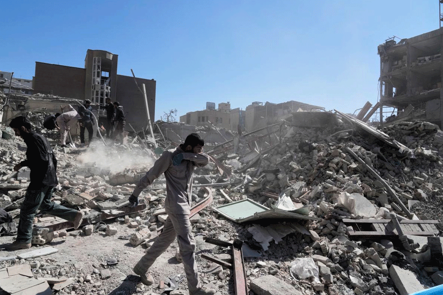 A group of men inspects the ruins of a police station struck Monday amid the U.S.‚ÄìIsraeli military campaign in Tehran, Iran, Tuesday, March 3, 2026.