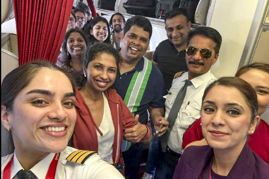 In this image posted on March 3, 2026, passengers and crew of Air India flight AI916D from Dubai arrive at the Indira Gandhi International Airport, in New Delhi. The airline said the flight was the first by an Indian carrier to land in the national capital amid the ongoing conflict in the Middle East.