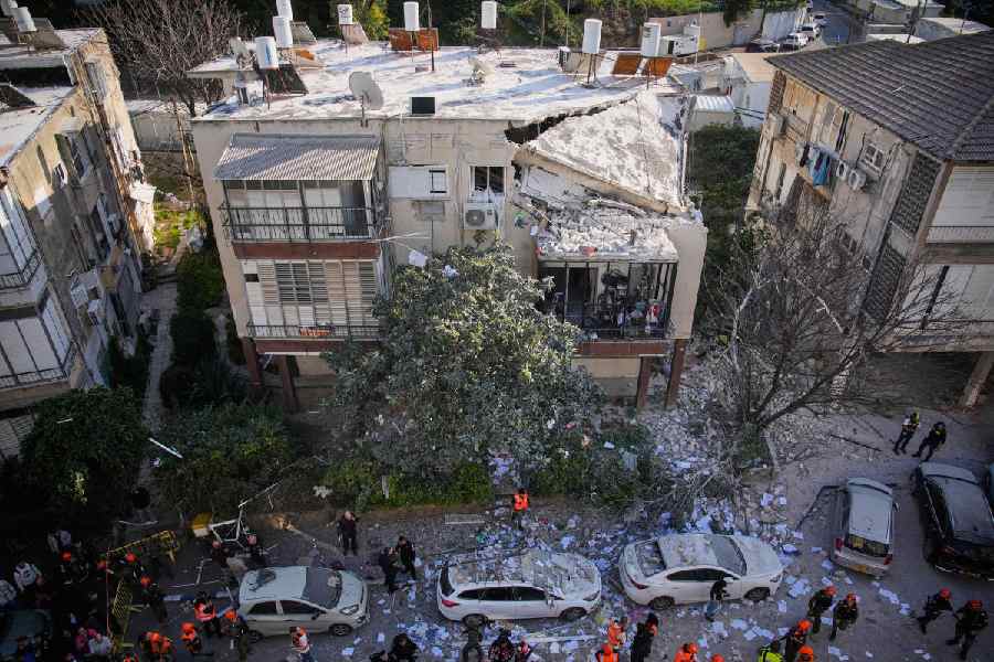 Officers from Israel's Home Front Command inspect a damaged apartment building after an Iranian missile strike in Ramat Gan, Israel, Tuesday, March 3, 2026