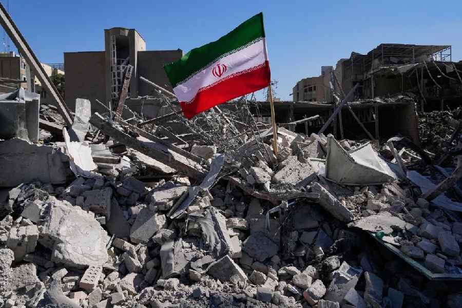 An Iranian flag is placed among the ruins of a police station in Tehran on Tuesday.