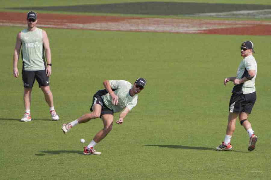(Clock-wise from top) New Zealand’s captain Mitchell Santner (centre) with teammates James Neesham (left) and Glenn Phillips during a training session at the Eden on Tuesday.