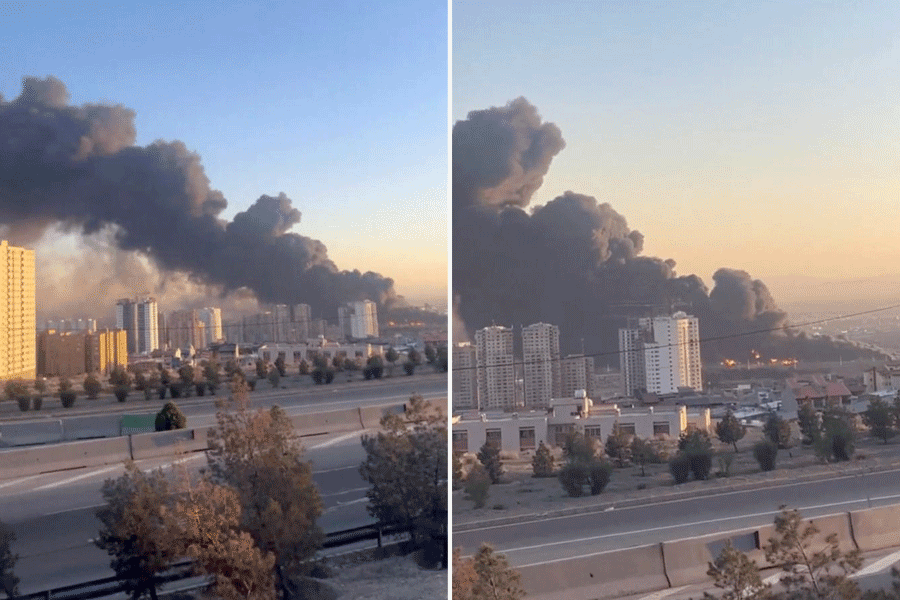 Smoke rises following reported airstrikes in Tehran, Iran.