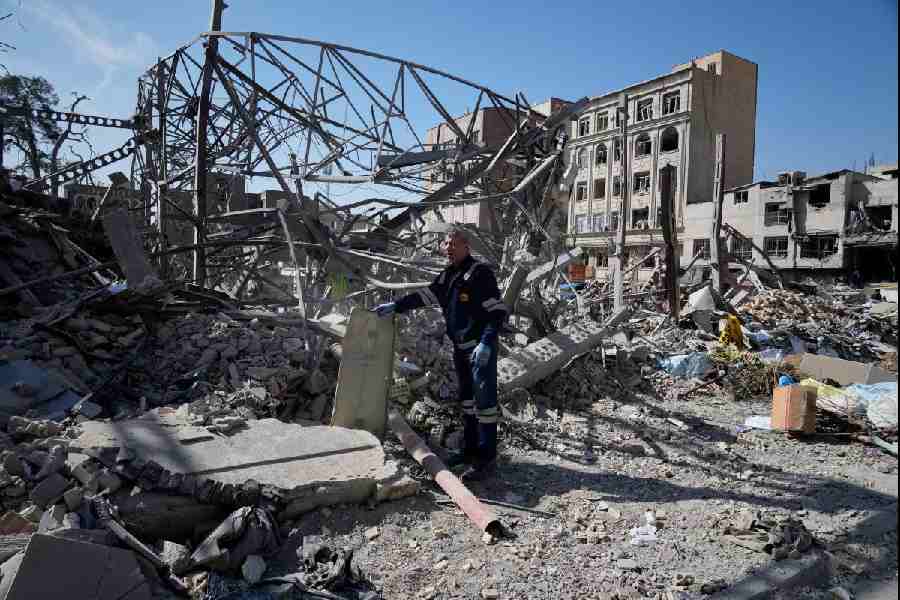 An electricity utility worker inspects the ruins of a police facility struck during the U.S.–Israeli military campaign in Tehran, Iran, Wednesday, March 4, 2026.