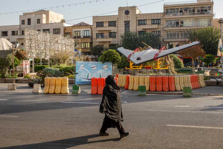 A woman walks past an Iranian Shahed drone displayed at a military exhibit in Tehran, Iran, Oct. 1, 2026