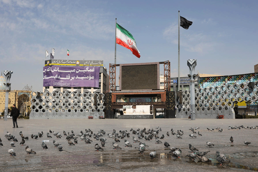 A black flag and an Iranian flag flutters in the wind, amid the U.S.-Israeli conflict with Iran, in Tehran, Iran, March 5, 2026.