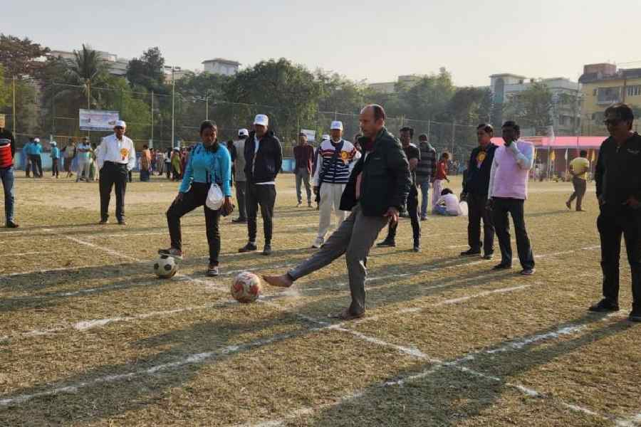 A man kicks a football towards the goal in EE Block. 