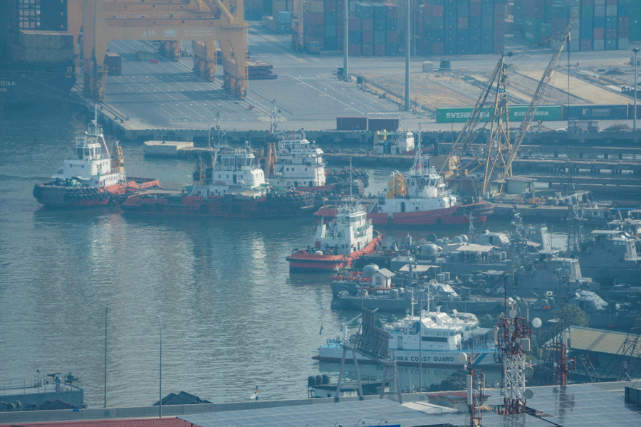 Tugboats and service vessels are seen through a window near the Western Naval Command Headquarters, at the Port of Colombo, in Colombo, Sri Lanka, March 6, 2026.