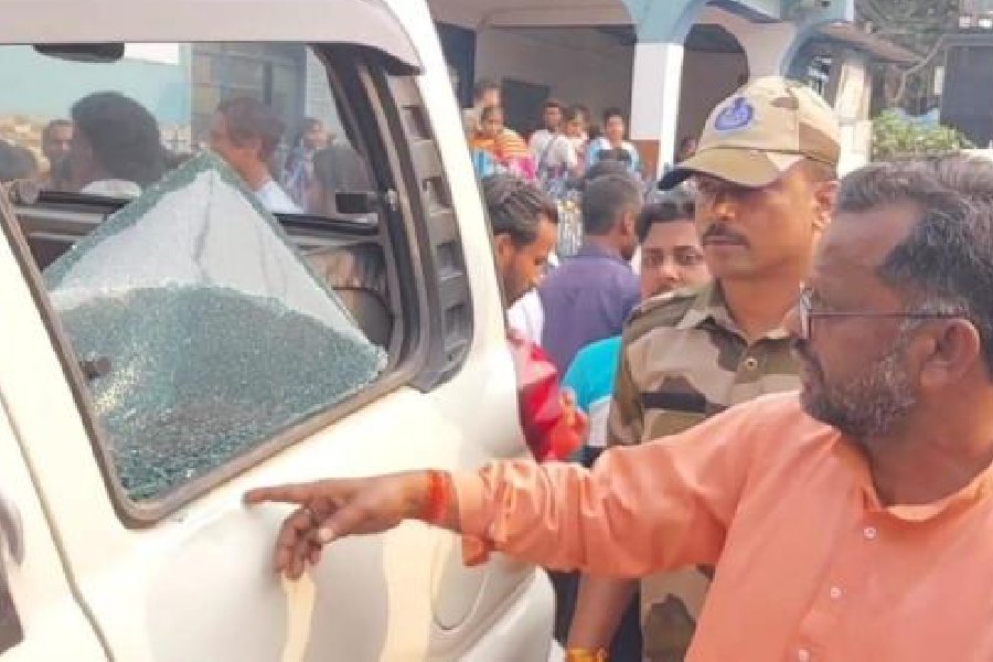 BJP MLA Baneshwar Mahato shows a broken window of his vandalised car at Balarampur in Purulia district on Friday