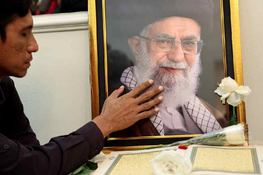 A man pays condolence while attending a prayer for Iran's late Supreme Leader Ayatollah Ali Khamenei