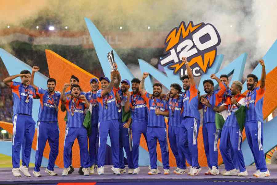 India's captain Suryakumar Yadav and teammates celebrate with the tournament trophy during the presentation ceremony after winning the ICC Men's T20 World Cup 2026, in Ahmedabad on Sunday.