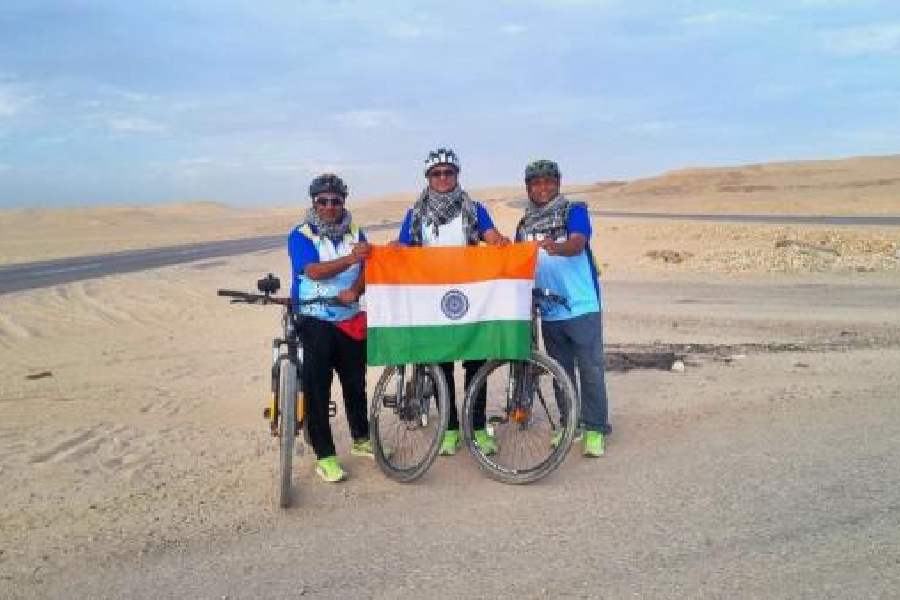The trio at the Valley of the Kings in Luxor and (right) through the Sahara on bicycles