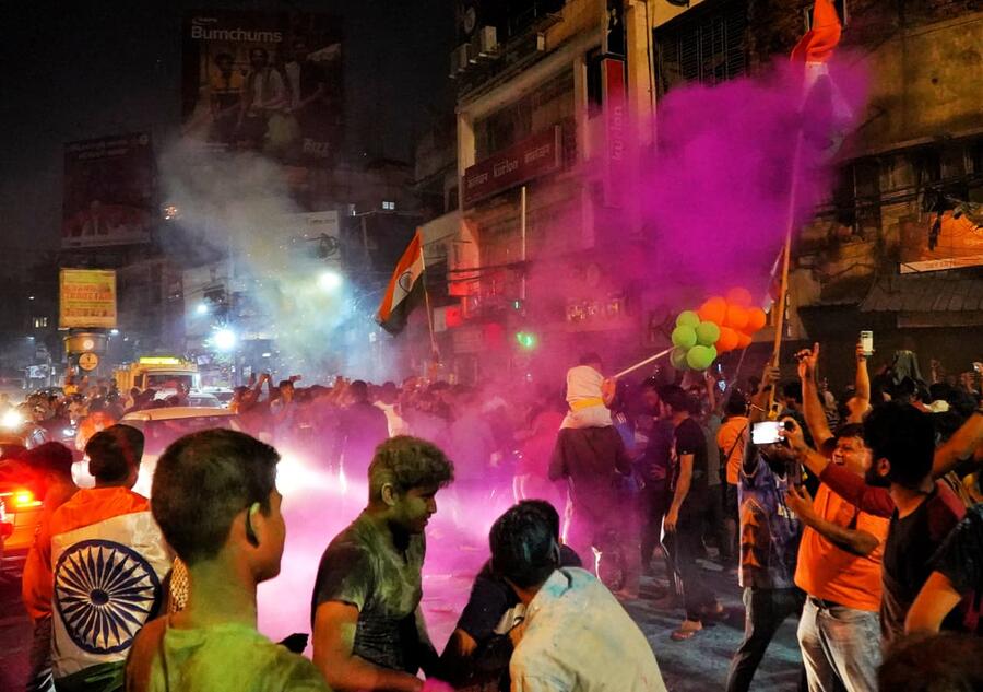 It was Holi and Diwali on the same night at many Kolkata localities as fans smeared each other with gulaal while fireworks lit up the sky.