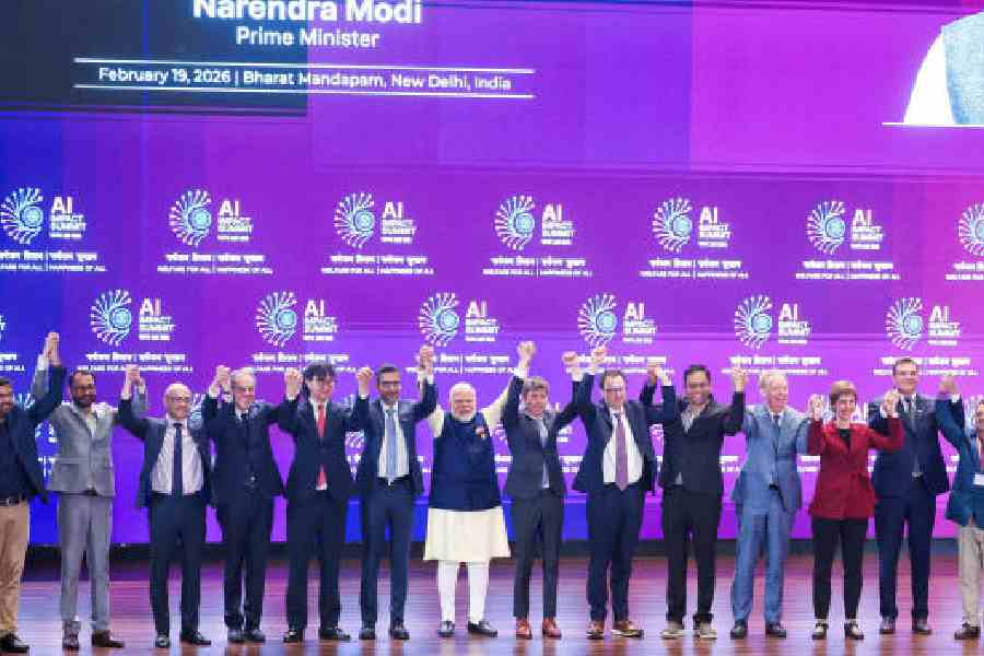 Sam Altman and Dario Amodei awkwardly touched elbows while others joined hands with PM Narendra Modi in New Delhi in February. (Reuters)